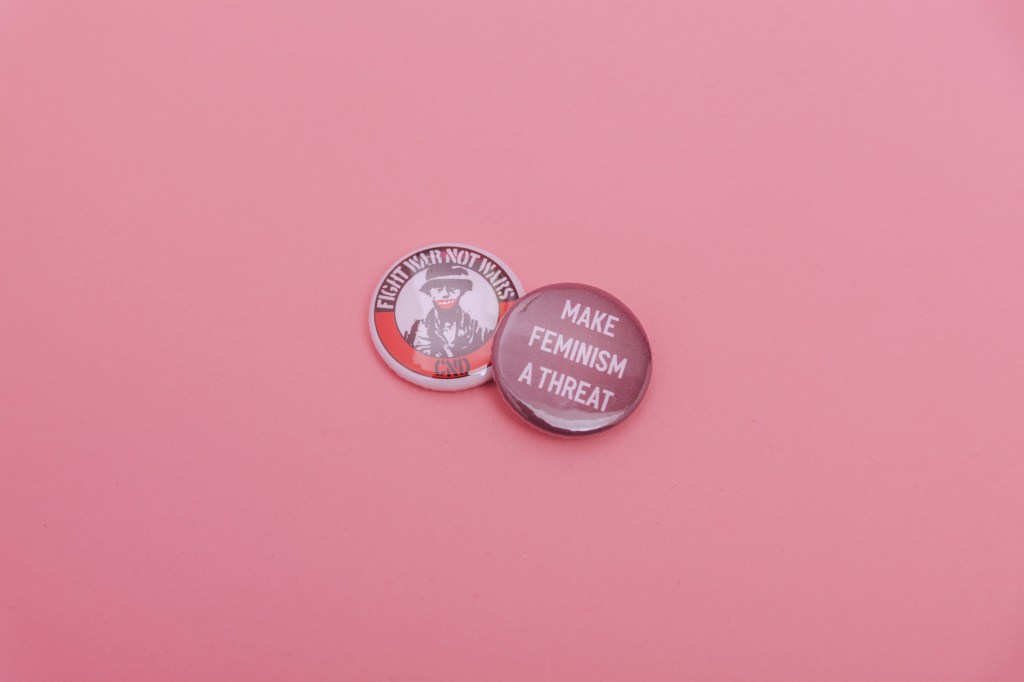 two leftist enamel pins