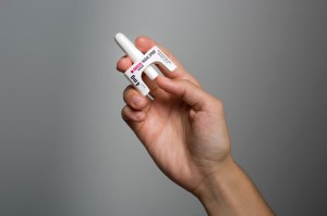 someone holding narcan, the naloxone nasal spray