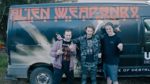 Alien Weaponry stand in front of their van.