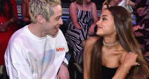 Pete Davidson and Arianna Grande looking at each other and smiling at the VMAs.