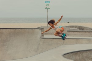 Michelle Steilen, founder of the Moxi Skate Girls, flying through the air in the skate park.