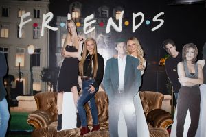 Women pose with cutouts of Freinds characters