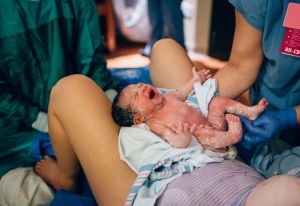 Woman who just gave birth holds baby