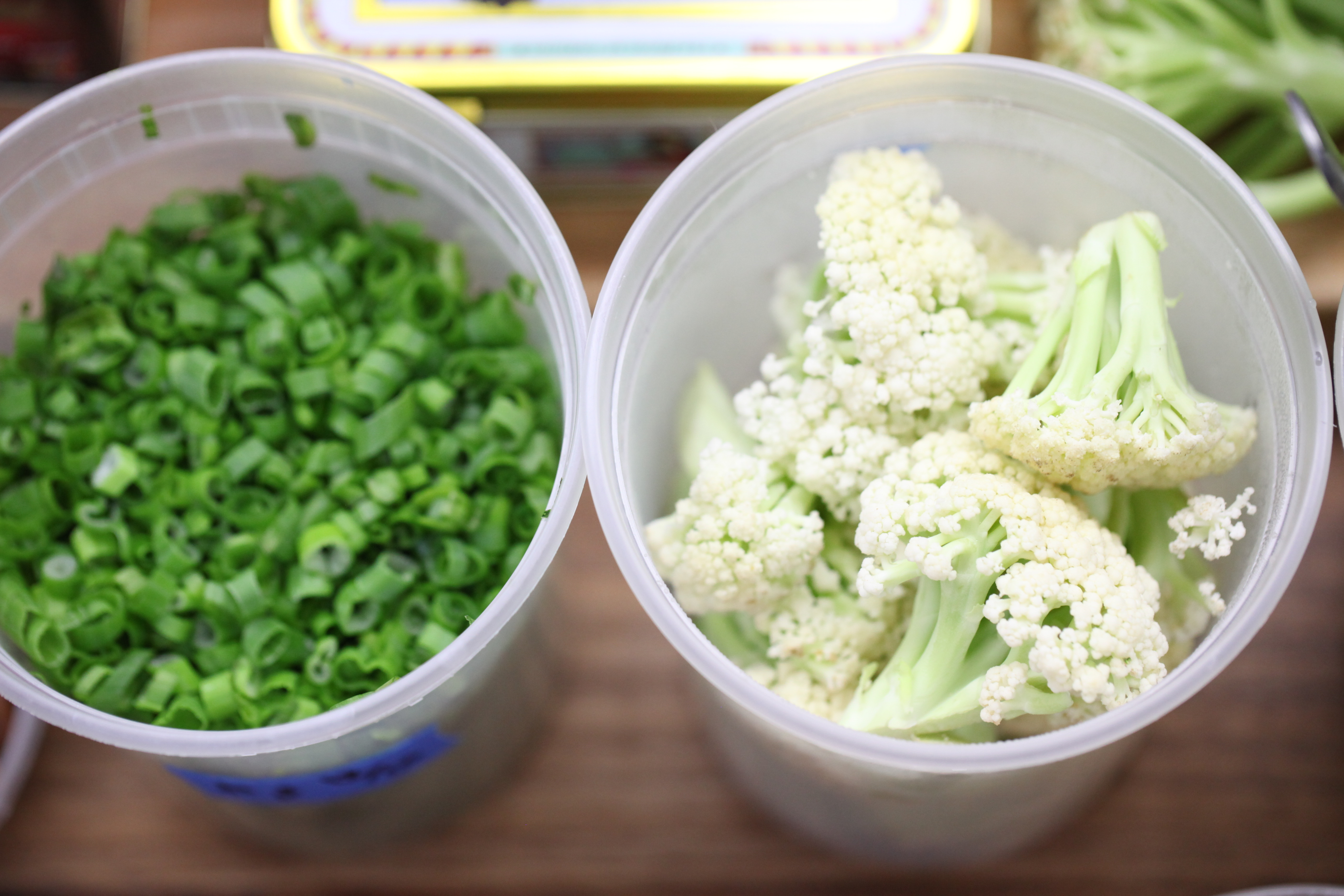 containers of scallions and chinese cauliflower