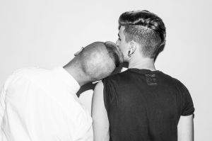 One man leaning on another man's shoulder