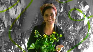 Vivien Sansour leaning on a tree in Palestine holding flowers