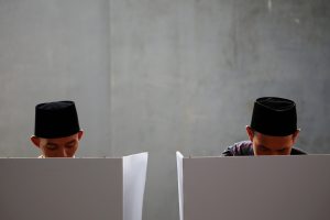 Two men vote at a polling booth in Bogor, West Java on April 17, 2019. Photo by Willy Kurniawan/Reuters