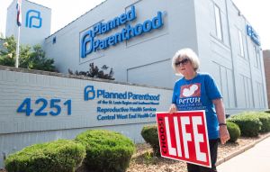 An anti-abortion protester stands outside the last abortion provider in Missouri