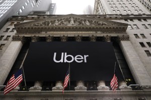 Uber banner and American flag flying on the New York Stock Exchange.