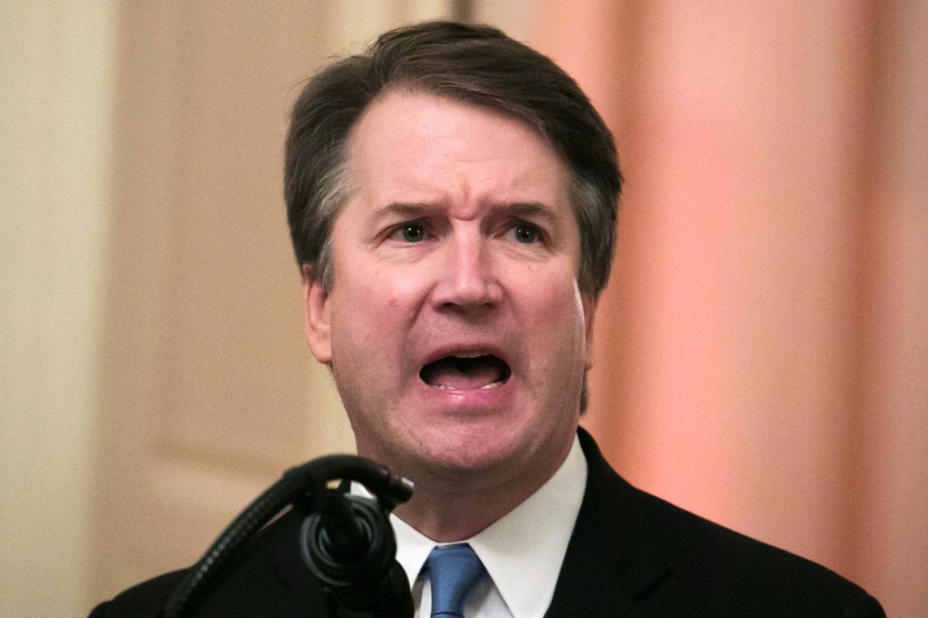 Brett Kavanaugh with his mouth open and his brow furrowed