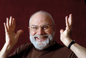 Oliver Sacks smiles and hold his hands in the air