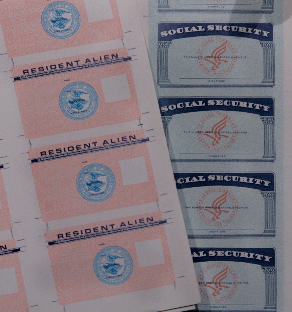Bogus documents, Resident Alien and Social Security cards, are displayed at a news conference Wednesday, April 25, 2007, in Chicago