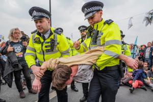 police carry extinction rebellion protester