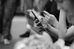 Commuters on a train on their phone