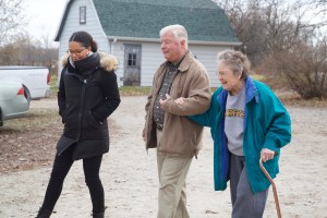 Uncommitted host and VICE News correspondent Antonia Hylton walks with Dave Helman and Joyce Garretson on the Garretson's 800-acre farm near Salem, Iowa. Photo by: Mark Lanning ​