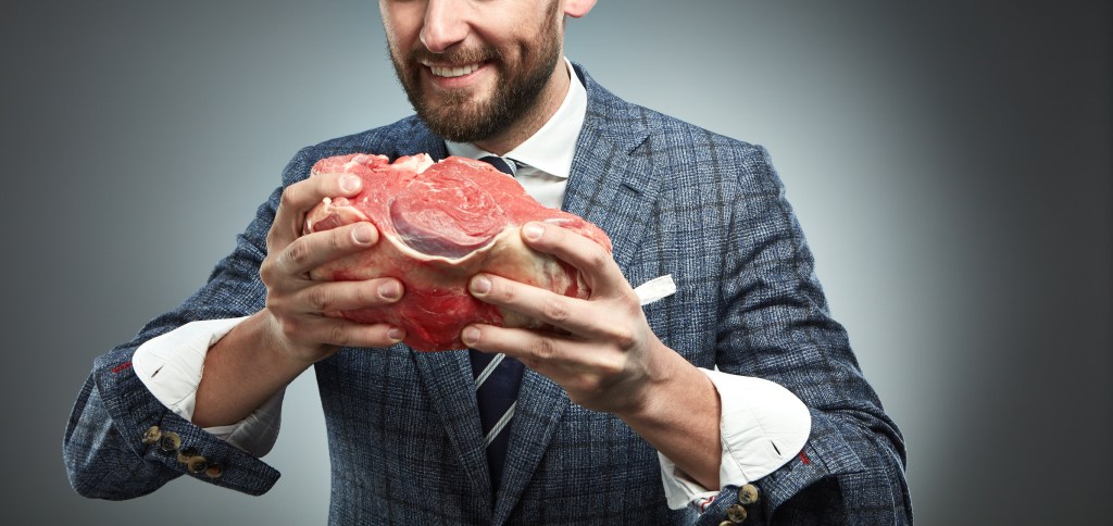 man holding raw meat