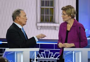 Democratic presidential hopefuls Former New York Mayor Mike Bloomberg and Massachusetts Senator Elizabeth Warren speak during a break in the ninth Democratic primary debate of the 2020 presidential campaign