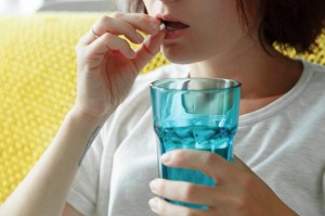 woman taking pill