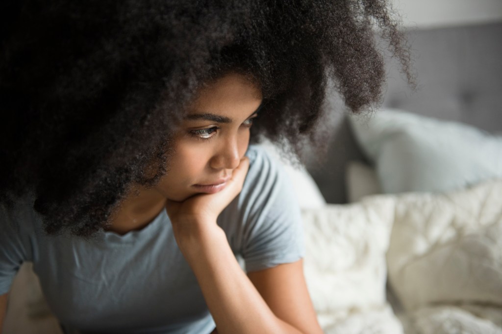 woman looking concerned / What to Do if You're Freaking Out About Your 401(k) Right Now