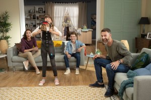 A family playing the Nintendo Switch fitness game Ring Fit Adventure.