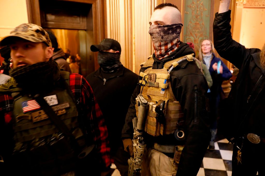 Protestors try to enter the Michigan House of Representative chamber and are being kept out by the Michigan State Police after the American Patriot Rally organized by Michigan United for Liberty protest for the reopening of businesses on the steps of the