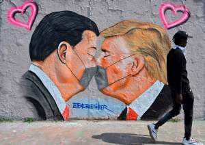 A mural painting by graffiti artist Eme Freethinker features likenesses of US President Donald Trump and Chinese premier Xi Jinping wearing face covers in Berlin on April 28, 2020 amid the new coronavirus COVID-19 pandemic.