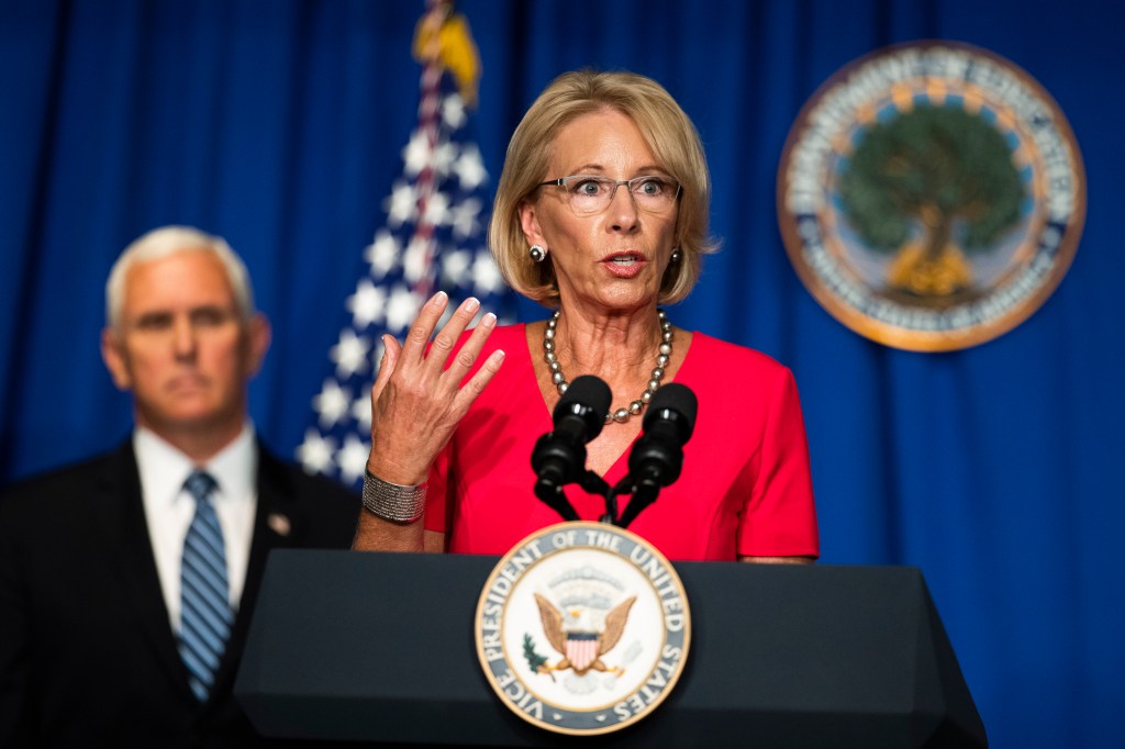 Education Secretary Betsy DeVos, with Vice President Mike Pence, speaks during a White House Coronavirus Task Force briefing at the Department of Education building Wednesday, July 8, 2020, in Washington.
