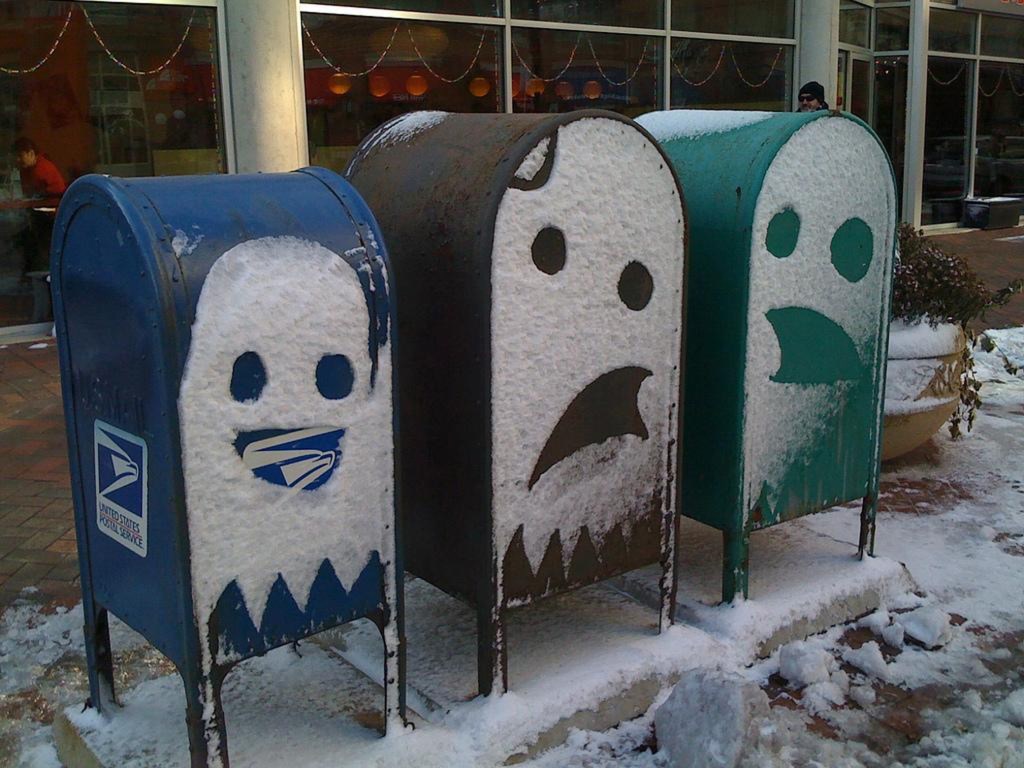 Three USPS mailboxes.