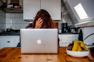Woman working from home at her laptop being sexually harassed