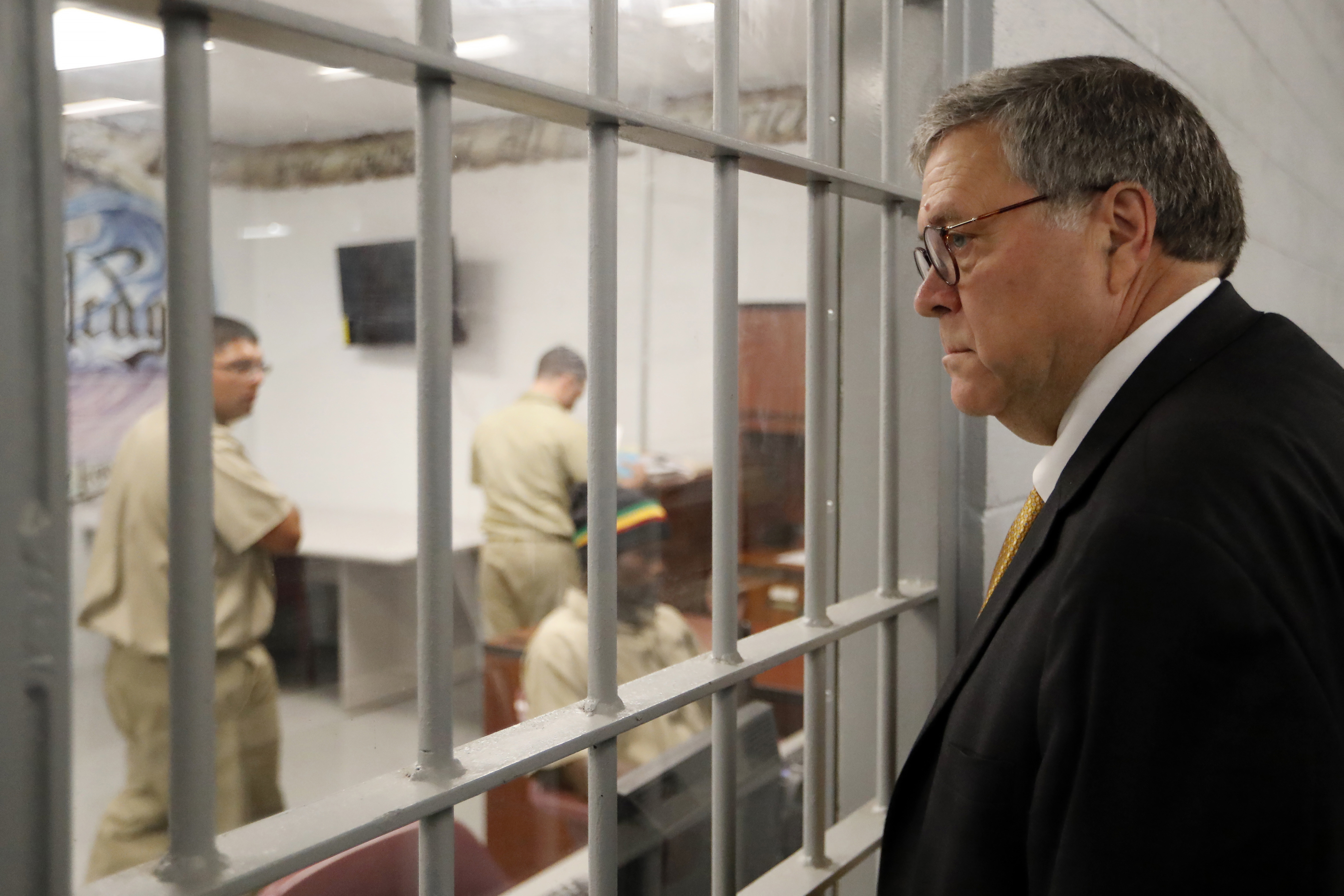 Attorney General William Barr watches as inmates work in a computer class during a tour of a federal prison in Edgefield, S.C. on July 8, 2019.