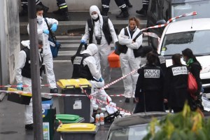 French police and forensic officers inspect the scene of an attack after several people were injured near the former offices of the French satirical magazine Charlie Hebdo​