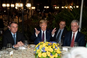 President Donald Trump speaks before a dinner with National Security Adviser Robert O'Brien, right, and Brazilian President Jair Bolsonaro, left, at Mar-a-Lago, Saturday, March 7, 2020, in Palm Beach, Fla.
