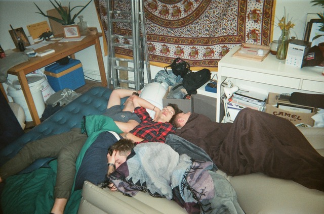 Four guys passed out on top of each other on inflatble mattrasses.