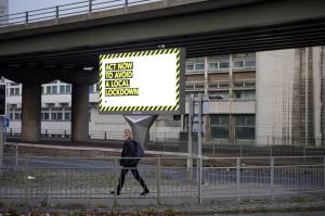 A coronavirus warning sign advises people entering Manchester city centre​.