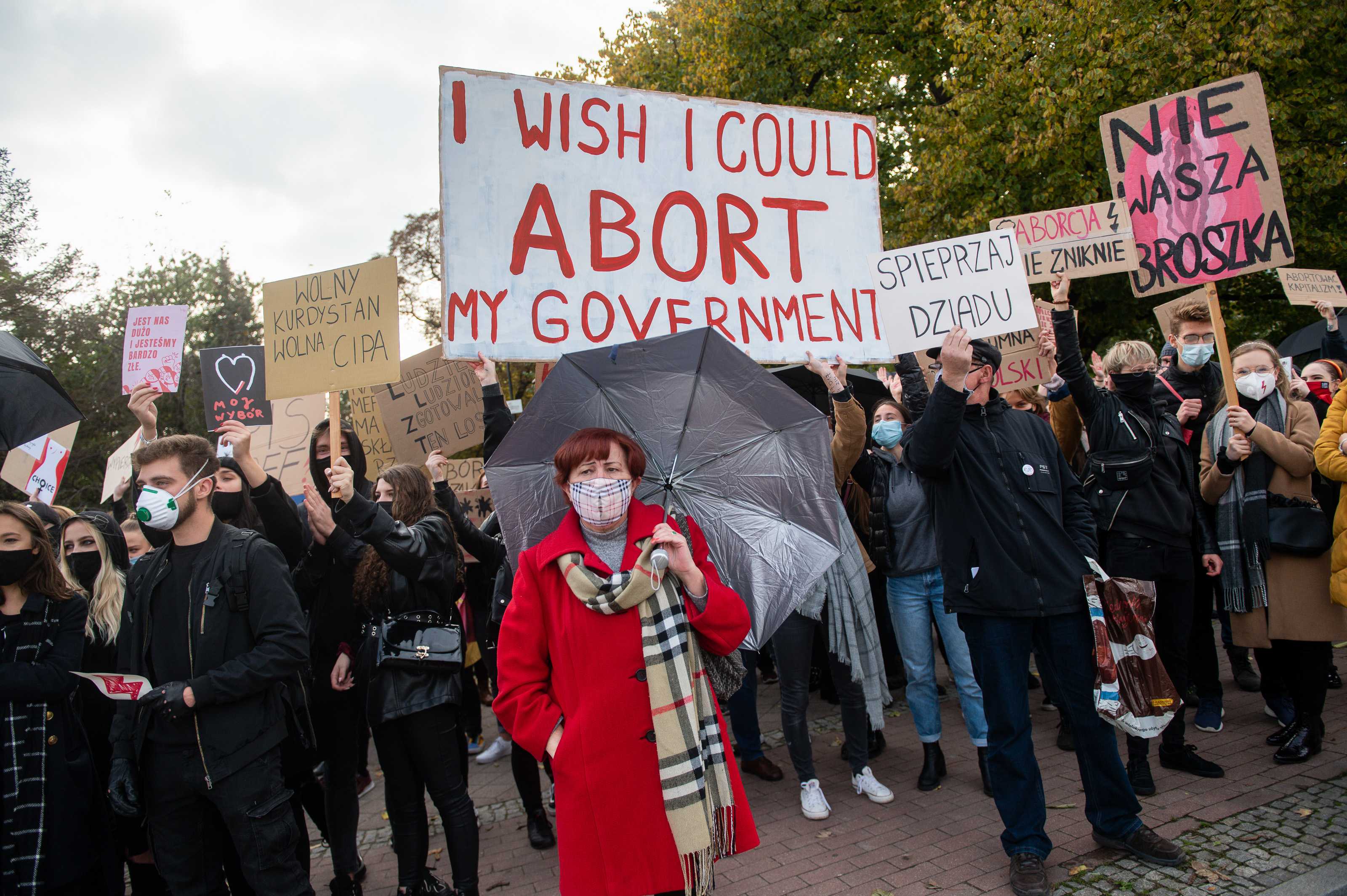 Protesters wearing face masks hold placards during the demonstration.