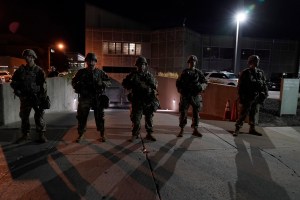 The National Guard protect the perimeter of government buildings in Kenosha, Wis. on Thursday, Aug. 27, 2020. People gathered for the fifth night to protest the Sunday police shooting of Jacob Blake.