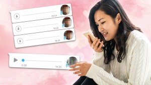 A woman uses her phone to send a voice note.