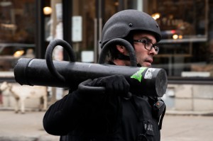 A police officer carries a battering ram as officers assemble at the Ubisoft building in Montreal, Friday, Nov. 13, 2020. THE CANADIAN PRESS/Paul Chiasson​