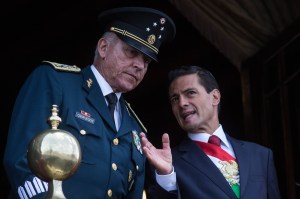 President of Mexico Enrique Pena Nieto (R) and Defense Secretary Salvador Cienfuegos Zepeda watch the annual military parade at Zocalo main square, in Mexico City, Mexico on September 16, 2016.