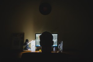 man on computer social media