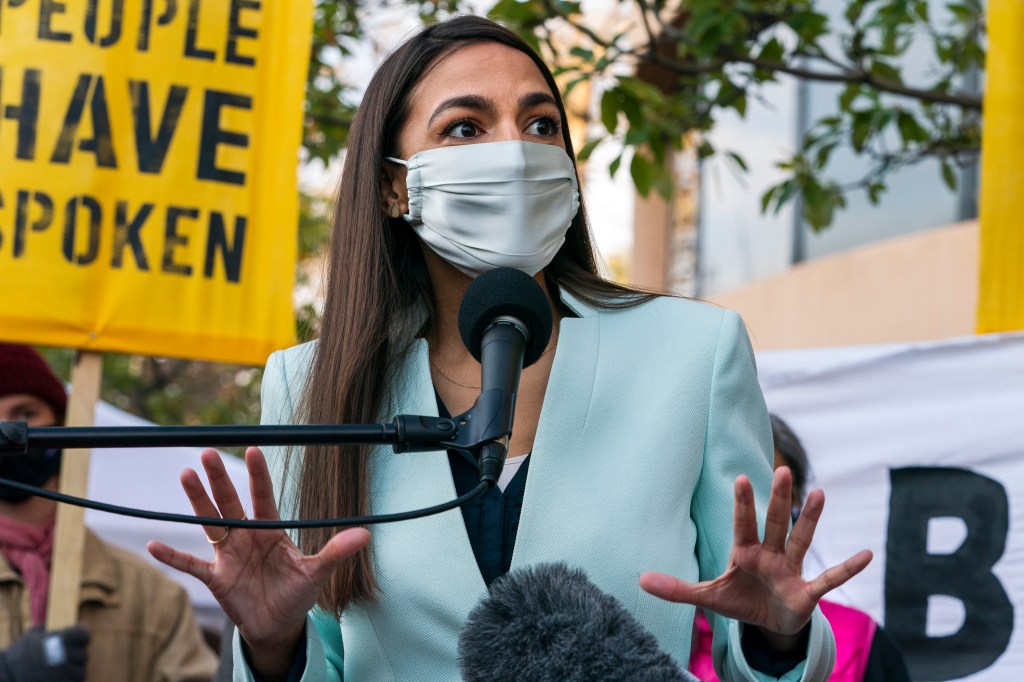 Rep. Alexandria Ocasio-Cortez, D-N.Y., speaks, Thursday, Nov. 19, 2020, outside the Democratic National Committee (DNC) Headquarters in Washington. (AP Photo/Jacquelyn Martin)
