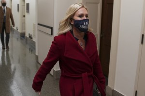 Representative Marjorie Taylor Green, a Republican from Georgia, wears a protective mask while walking through the Longworth House Office building in Washington, D.C., U.S., on Wednesday, Feb. 3, 2021.