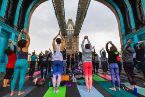 People practicing yoga on Tower Bridge, London, UK. Photo: Steve Vidler / Alamy Stock Photo