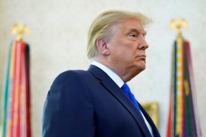 President Donald Trump listens to a reporter's question after awarding the Presidential Medal of Freedom, the highest civilian honor, to Olympic gold medalist and former University of Iowa wrestling coach Dan Gable in the Oval Office of the White House, M