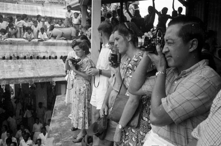 audience taking photographs at Theemithi festival at the Sri Mariamman Temple in the 1950s