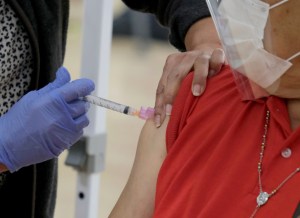 A man gets his first dose of the Moderna vaccine from Connie Castro, a Los Angeles Unified School District nurse, as LAUSD's first vaccination site opened at the Roybal Learning Center, Wednesday, Feb. 17, 2021, in Los Angeles. 9