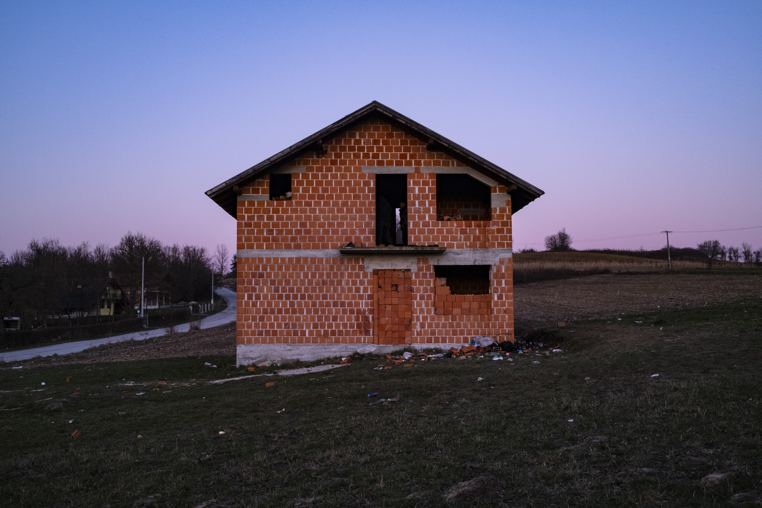 An unfinished farmhouse in Una-Sana, Bosnia, where Afghan families are staying before trying to cross into Croatia by foot.
