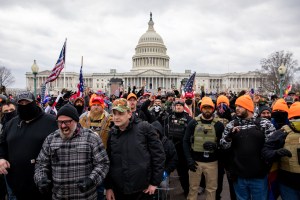 Members of the Proud Boys make a hand gesture while walking near the US Capitol in Washington, DC on Wednesday, January 6, 2021.