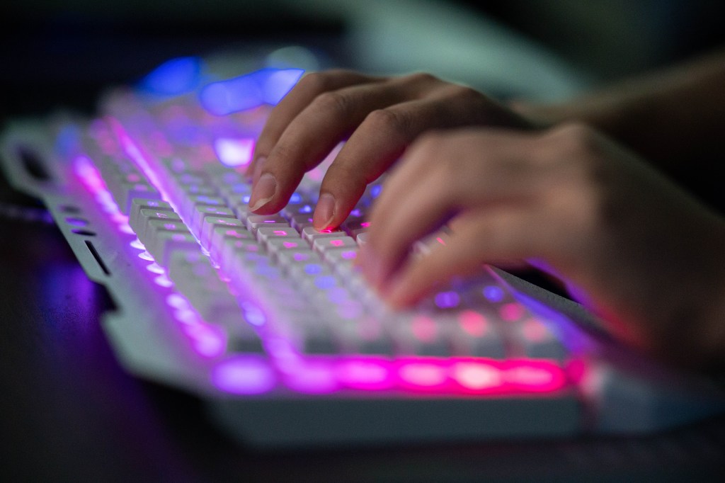 Hands typing on a keyboard.