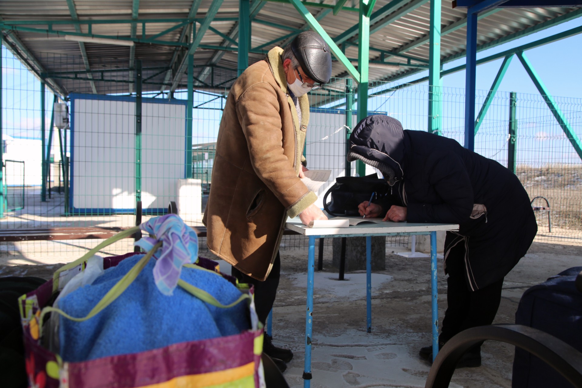 Le persone seguono le procedure per il COVID al confine con Donetsk. Foto: Valentin Sprinchak/TASS via Getty Images